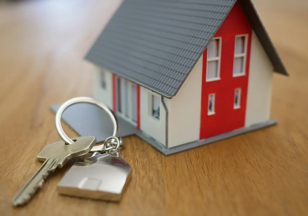 A small house-shaped keychain for mortgage contract A Small House Shaped Keychain For Mortgage Contract escrow accounts